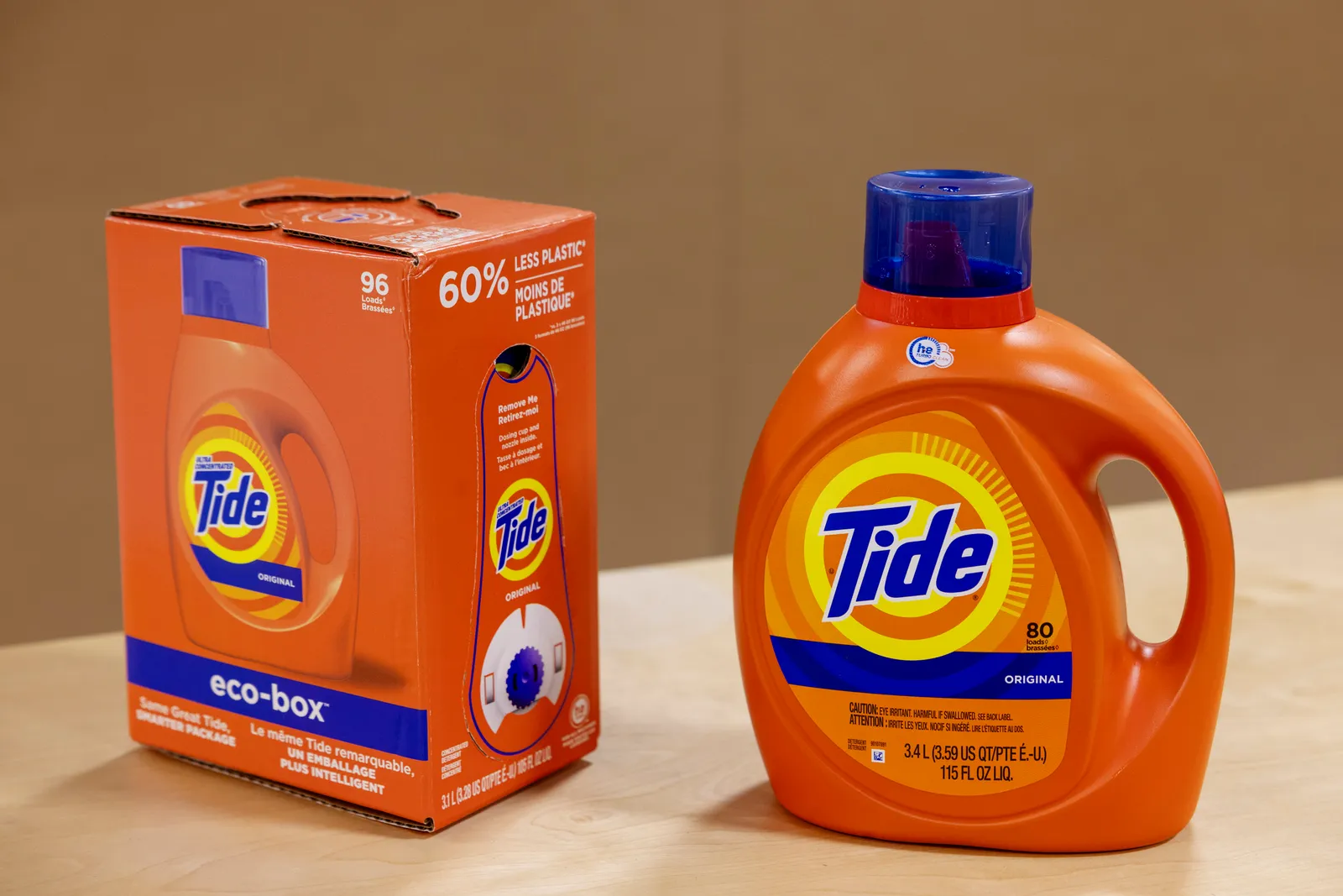 A bag-in-box package of liquid Tide detergent next to a plastic jug of liquid Tide detergent.